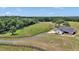 Aerial view of the expansive grounds featuring a home, mature trees, and green pastures at 1631 W Hwy 329, Citra, FL 32113