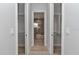 Hallway with closet and view into bathroom featuring tile-lined walls, a modern tub, and a sleek design at 1631 W Hwy 329, Citra, FL 32113