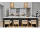 Open kitchen with island seating, marble countertops, modern lighting, and stainless steel appliances at 1631 W Hwy 329, Citra, FL 32113