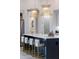 Kitchen island with marble countertop, seating, stainless steel appliances, and decorative pendant lights at 1631 W Hwy 329, Citra, FL 32113