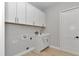 White laundry room with modern cabinets and sink at 1631 W Hwy 329, Citra, FL 32113