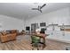 Open-concept living room and kitchen with stainless steel appliances and a cozy leather sofa at 1631 W Hwy 329, Citra, FL 32113