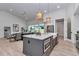 Bright, open living space connected to kitchen with island, dining area, and backyard view at 1631 W Hwy 329, Citra, FL 32113