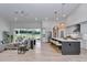 Open-concept living area with a modern kitchen and access to the outdoor view at 1631 W Hwy 329, Citra, FL 32113