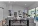 Bright living room featuring vaulted ceiling, gray couches, modern decor, and natural lighting at 1631 W Hwy 329, Citra, FL 32113