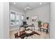 Bright office features a large window, modern ceiling fan, and eclectic decorations for a unique and inviting workspace at 1631 W Hwy 329, Citra, FL 32113