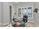Bright office features a large window, modern ceiling fan, and eclectic decorations for a unique and inviting workspace at 1631 W Hwy 329, Citra, FL 32113