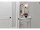 Stylish powder room featuring a gold mirror and modern vanity at 1631 W Hwy 329, Citra, FL 32113