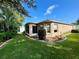 The backyard features a screened-in porch, well-maintained landscaping, and green lawn at 16405 Sw 14Th Avenue Rd, Ocala, FL 34473