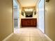 Bathroom with dual sinks, wood cabinets, a walk-in shower, tile flooring, and contemporary lighting fixtures at 16405 Sw 14Th Avenue Rd, Ocala, FL 34473