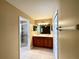 Bathroom with dual sinks, wood cabinets, a walk-in shower, tile flooring, and contemporary lighting fixtures at 16405 Sw 14Th Avenue Rd, Ocala, FL 34473