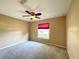 Bedroom has a ceiling fan and a window with a red shade at 16405 Sw 14Th Avenue Rd, Ocala, FL 34473