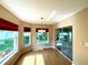 Bright breakfast nook with wood floors, modern chandelier, windows and sliders to screened lanai and backyard at 16405 Sw 14Th Avenue Rd, Ocala, FL 34473