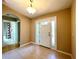 Bright foyer with tile flooring, and a white front door with sidelights and transom window at 16405 Sw 14Th Avenue Rd, Ocala, FL 34473