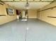 Spacious garage featuring epoxy floors, utility sink, and overhead lighting at 16405 Sw 14Th Avenue Rd, Ocala, FL 34473
