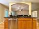 Kitchen breakfast bar area showcases granite countertops, stainless steel dishwasher, and access to other rooms at 16405 Sw 14Th Avenue Rd, Ocala, FL 34473