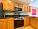 Updated kitchen features modern appliances, granite countertops, and stylish wood cabinetry at 16405 Sw 14Th Avenue Rd, Ocala, FL 34473