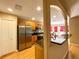 Modern kitchen features a breakfast bar with granite countertops, wooden cabinets, and stainless appliances at 16405 Sw 14Th Avenue Rd, Ocala, FL 34473