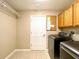 Interior laundry room with cabinets, wire shelving, and door to exterior at 16405 Sw 14Th Avenue Rd, Ocala, FL 34473