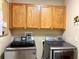 Laundry room featuring stainless steel Samsung washer and dryer and storage cabinets at 16405 Sw 14Th Avenue Rd, Ocala, FL 34473