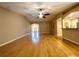 Open-concept living room featuring hardwood floors, a ceiling fan, and an arched entry to the kitchen at 16405 Sw 14Th Avenue Rd, Ocala, FL 34473