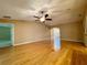 Living room featuring hardwood floors, ceiling fan, and an arched entry leading to other rooms at 16405 Sw 14Th Avenue Rd, Ocala, FL 34473
