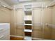 Walk-in closet featuring built-in shelving and custom storage, and hardwood flooring at 16405 Sw 14Th Avenue Rd, Ocala, FL 34473