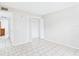 A bright, spacious bedroom with tile flooring and a closet at 1801 Caralee Blvd # 2, Orlando, FL 32822