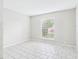 Neutral bedroom featuring tile flooring and a large window with blinds at 1801 Caralee Blvd # 2, Orlando, FL 32822