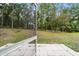 View from the screen porch of the lush, green backyard with mature trees at 19028 Sw 101 Pl, Dunnellon, FL 34432