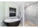 Modern bathroom featuring a soaking tub under window and a separate shower with marble tile at 19028 Sw 101 Pl, Dunnellon, FL 34432