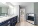 Bathroom featuring a large vanity with drawers, decorative mirrors, and tiled floors at 19028 Sw 101 Pl, Dunnellon, FL 34432