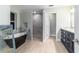 Modern bathroom featuring a soaking tub, walk-in shower, tiled walls, and stylish vanity at 19028 Sw 101 Pl, Dunnellon, FL 34432