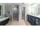 Elegant bathroom featuring a soaking tub, walk-in shower, and modern vanity at 19028 Sw 101 Pl, Dunnellon, FL 34432