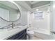 Bathroom with round mirror and shower-tub combo with white subway tile at 19028 Sw 101 Pl, Dunnellon, FL 34432
