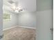 Bedroom featuring a ceiling fan, neutral carpeting and window with blinds at 19028 Sw 101 Pl, Dunnellon, FL 34432