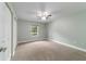 Spacious bedroom featuring a ceiling fan, window, and neutral carpeting at 19028 Sw 101 Pl, Dunnellon, FL 34432