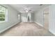 Carpeted bedroom with soft green walls, a ceiling fan, and plenty of natural light at 19028 Sw 101 Pl, Dunnellon, FL 34432