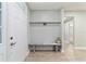 Inviting entryway with light wood flooring, a bench and coat rack, offering a welcoming space at 19028 Sw 101 Pl, Dunnellon, FL 34432