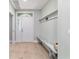 Inviting entryway with light wood-look tile and coat rack with bench at 19028 Sw 101 Pl, Dunnellon, FL 34432