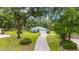 Aerial view of a charming single-story home with a long driveway and mature trees at 19028 Sw 101 Pl, Dunnellon, FL 34432