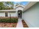 The front entrance features a walkway lined with lush landscaping at 19028 Sw 101 Pl, Dunnellon, FL 34432