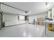 Spacious garage with white storage cabinets and door to the backyard at 19028 Sw 101 Pl, Dunnellon, FL 34432