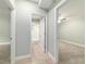 Hallway with multiple doorways showing access to a bedroom and bathroom at 19028 Sw 101 Pl, Dunnellon, FL 34432