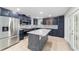 Modern kitchen featuring dark cabinetry, stainless steel appliances, and a center island at 19028 Sw 101 Pl, Dunnellon, FL 34432