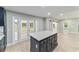 Kitchen island featuring shaker cabinets, a gray countertop, and wood-look flooring at 19028 Sw 101 Pl, Dunnellon, FL 34432