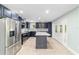 Bright kitchen features stainless steel appliances, center island, mosaic backsplash, and french doors at 19028 Sw 101 Pl, Dunnellon, FL 34432
