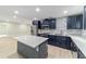 Stylish kitchen with blue cabinets, stainless appliances, a center island, and an open layout at 19028 Sw 101 Pl, Dunnellon, FL 34432