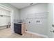 Practical laundry room with blue cabinets, tiled backsplash, and laundry connections at 19028 Sw 101 Pl, Dunnellon, FL 34432