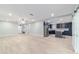 Bright open living space with modern flooring, recessed lighting, and a seamless flow to the kitchen at 19028 Sw 101 Pl, Dunnellon, FL 34432